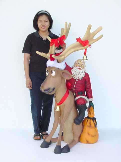 Funny Reindeer sitting with Santa Claus